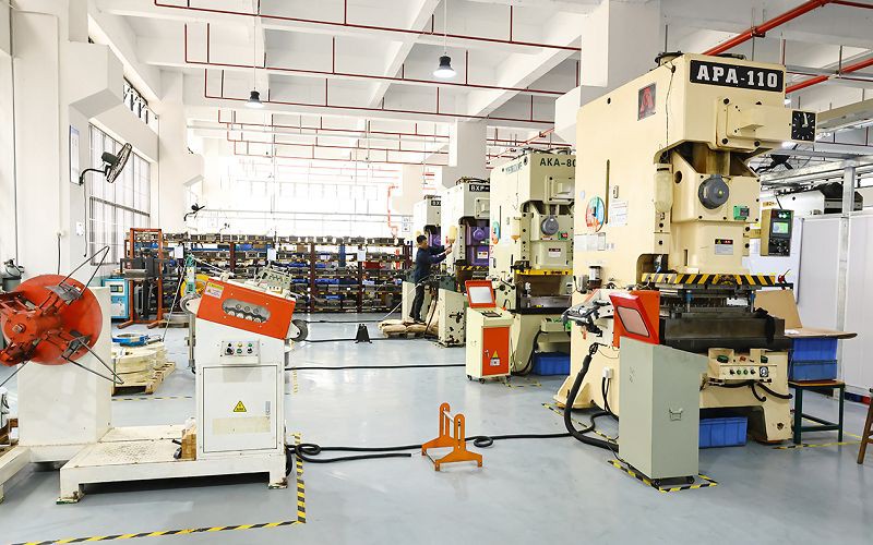Stamping floor with coil decoilers and feeders lined up in front of yellow APA-110 and AKA-80 presses
