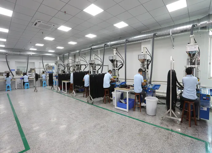 Row of vertical overmolding machines in a bright workshop