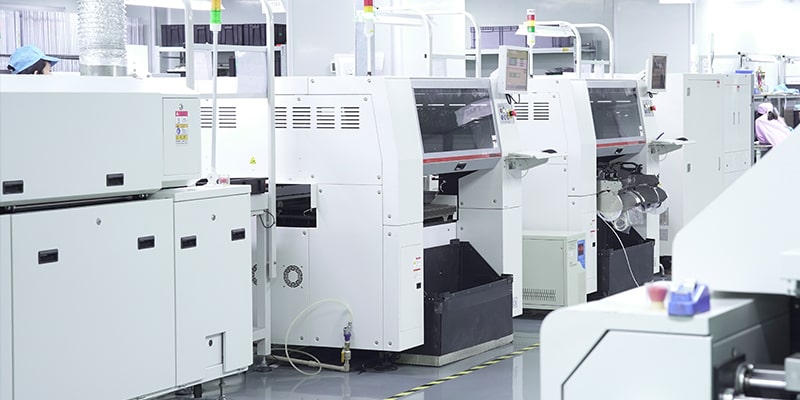 SMT assembly line of white pick-and-place machines in a clean workshop