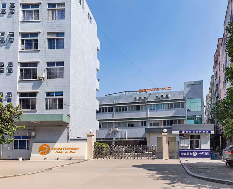 Romtronic factory gate and buildings with the company sign