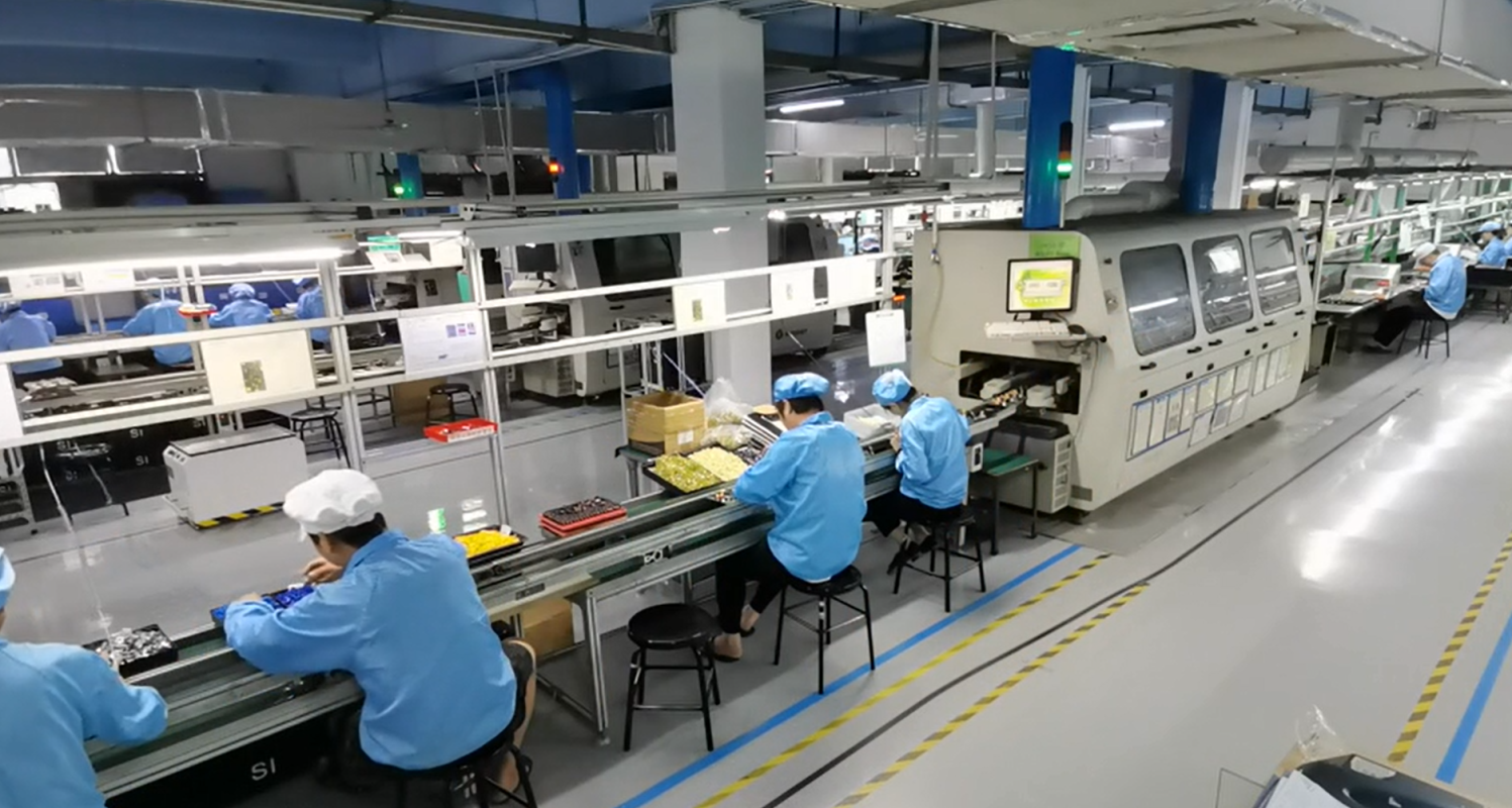 Through-hole and assembly line with operators at workbenches