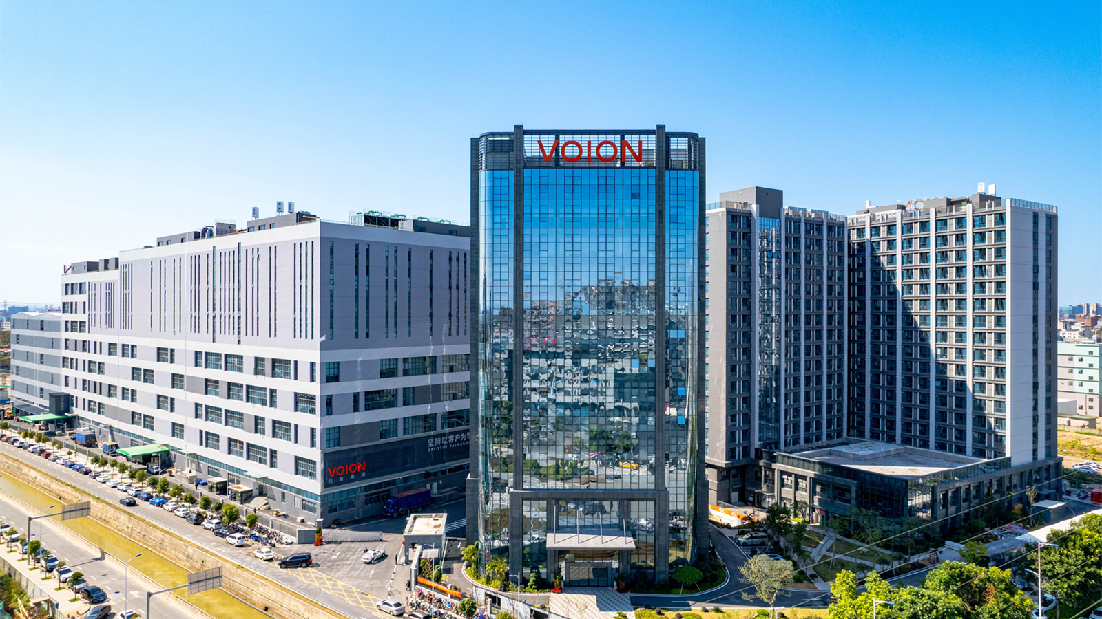 Aerial view of a Voion office tower and factory buildings with the VOION sign on the roof