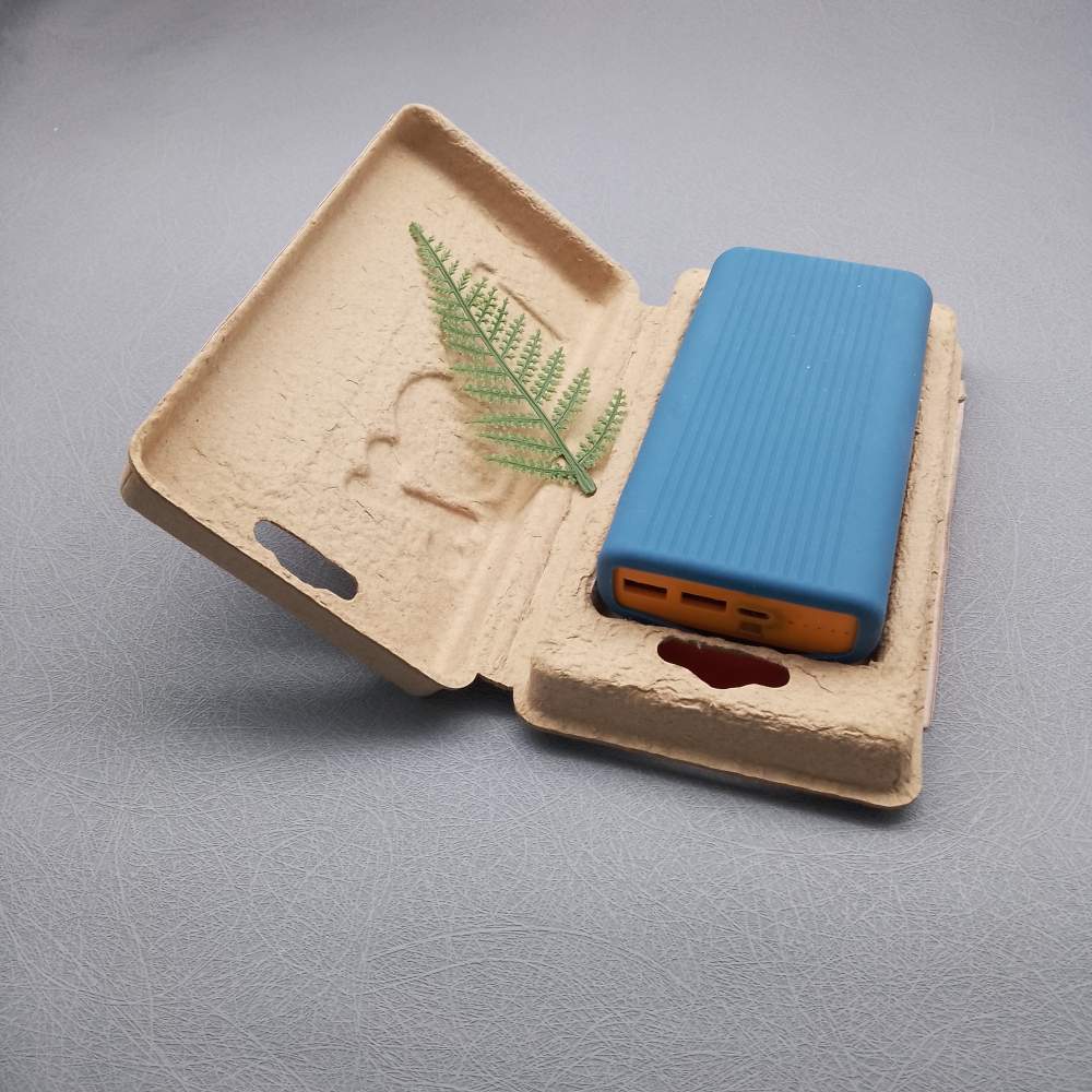 Brown molded pulp insert holding a power bank